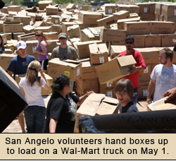 Volunteers in San Angelo load boxes on a Wal-Mart Truck