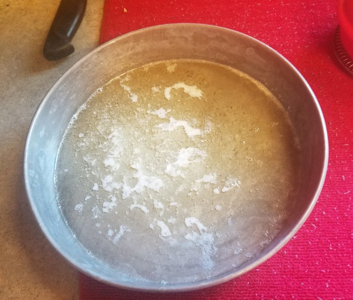 Pan with melted butter for rolls.