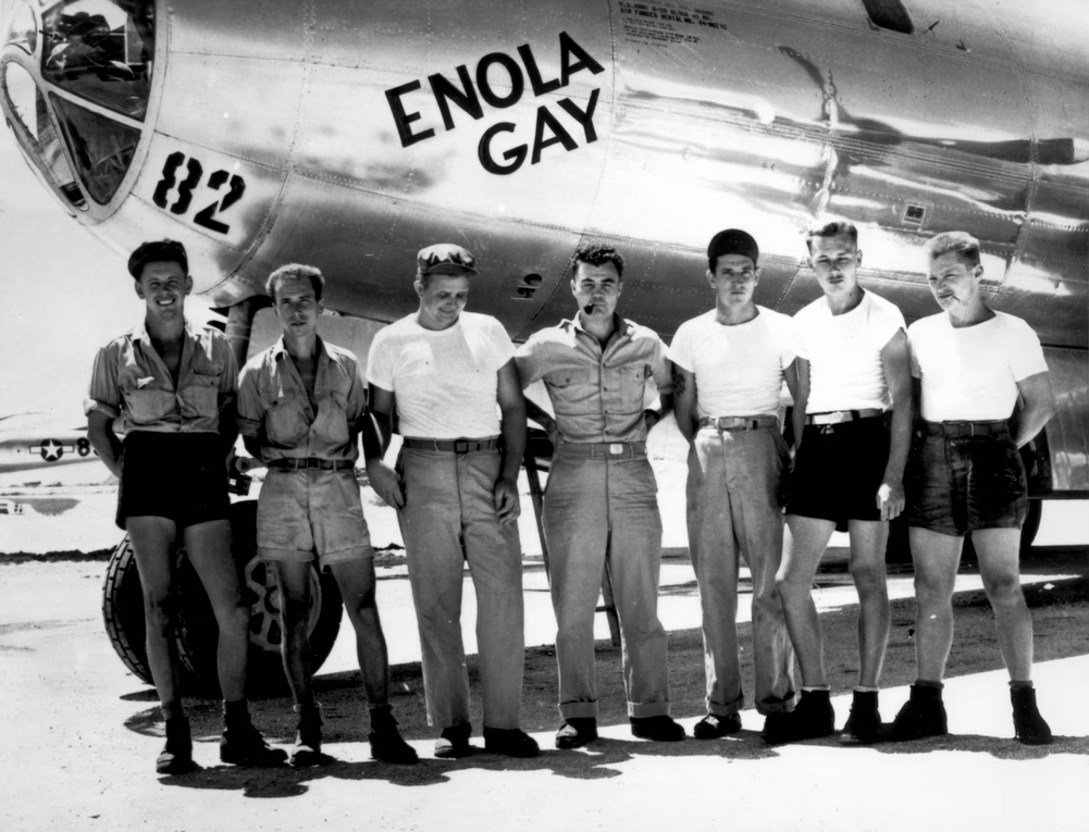 The crew of the Enola Gay B-29 Superfortress poses for a photo in front of the bomber in the Mariana Islands in 1945. The pilot, Army Air Forces Col. Paul W. Tibbets, is in the center of the group. 